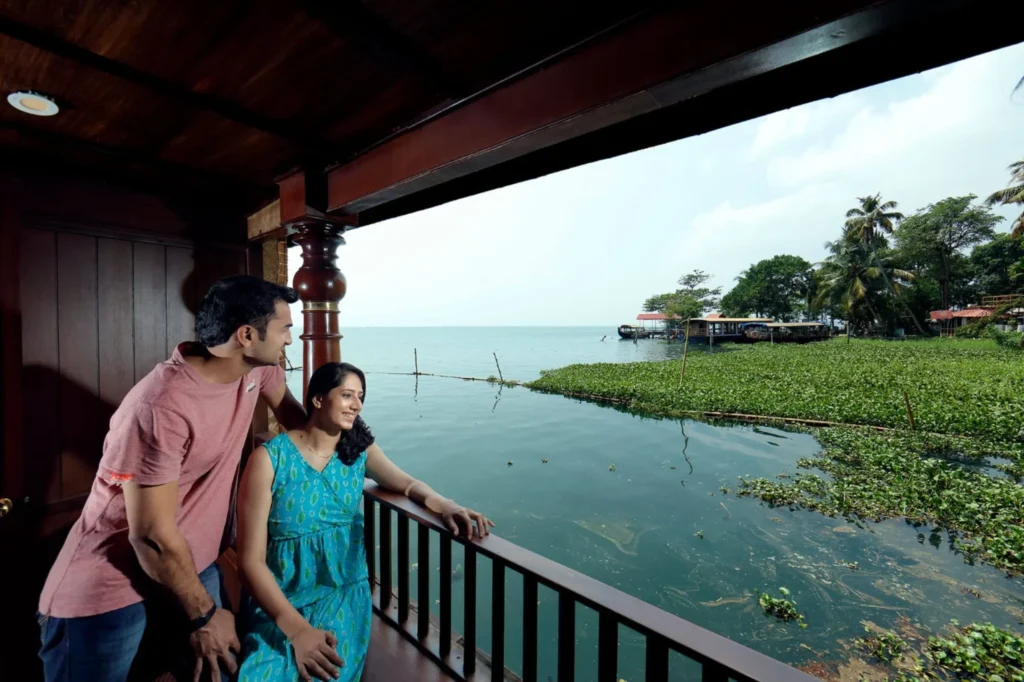 Couple enjoying Kerala backwater views during houseboat honeymoon
