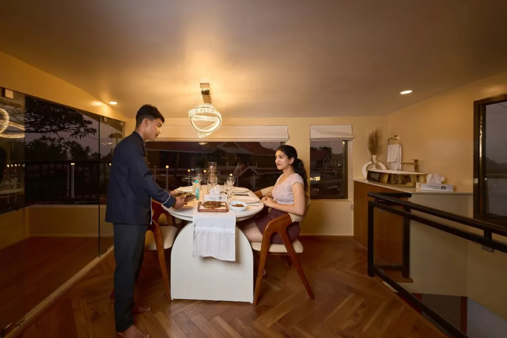 Couple at a private dinner table on board a luxury houseboat in Alleppey